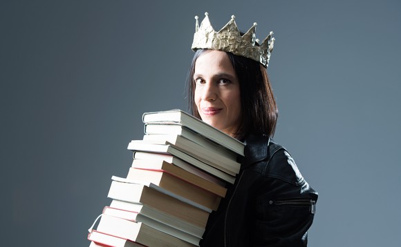 Frau mit Krone und einem riesigen Bücherstapel in den Händen