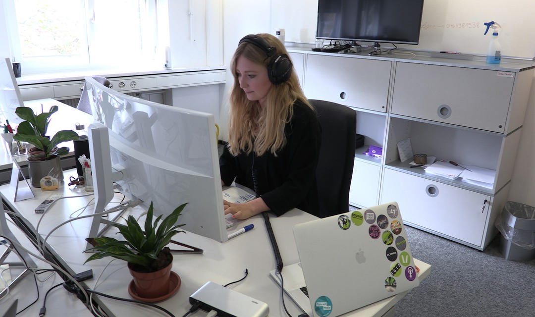 Sarah sitzt am Computer in ihrem Büro